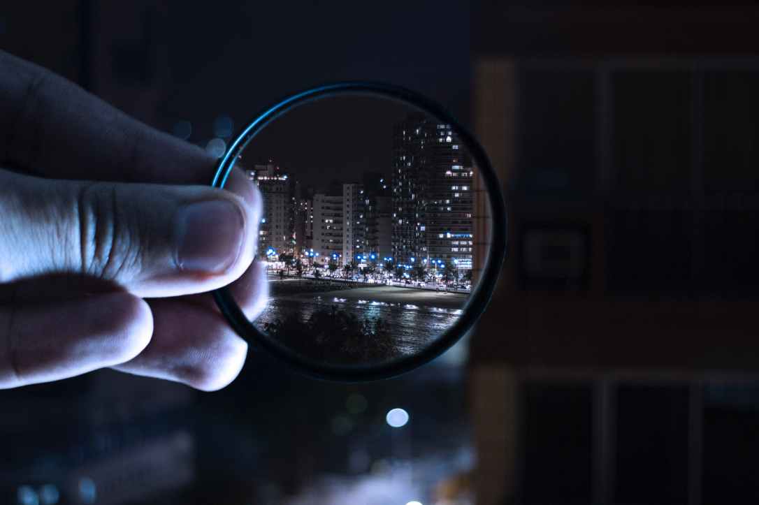 person holding magnifying glass